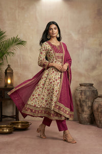Woman in red and cream kurti set in a warm-toned room.
