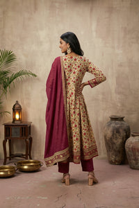 Woman in red and cream kurti set in a warm-toned room.