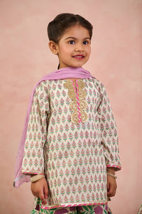 A young girl modeling a traditional Indian salwar kameez set. The outfit features a cream-colored kurta with pink and green printed motifs, a pink inner lining, and gold embroidery on the chest.